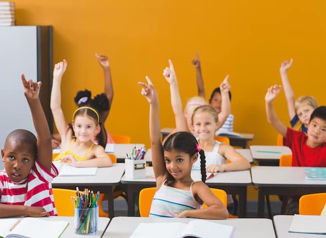 K square edutainment Tuition students raising hands